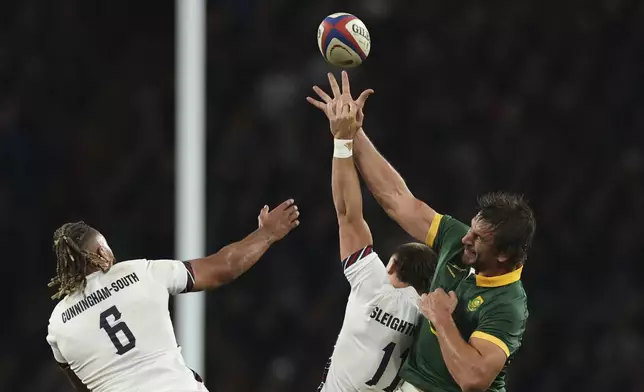 South Africa's Eben Etzebeth, right leaps for a high ball with England's Ollie Sleightholme , center and England's Chandler Cunningham-South during the Autumn Nations series rugby union match between England and South Africa, at Twickenham, in London, Saturday, Nov. 16, 2024. (AP Photo/Ian Walton)