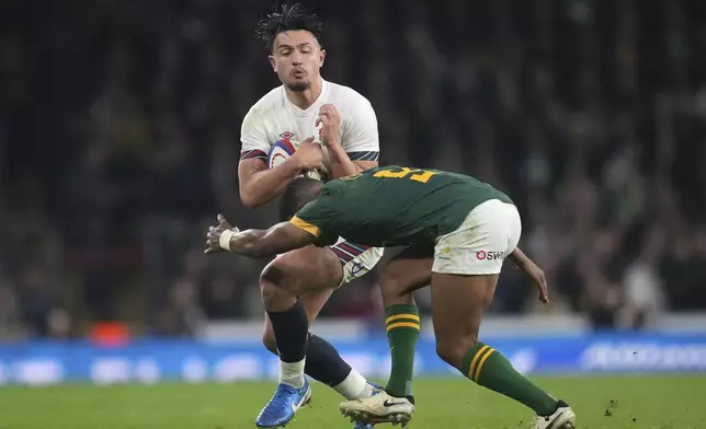 England's Marcus Smith is tackled by South Africa's Grant Williams during the Autumn Nations series rugby union match between England and South Africa, at Twickenham, in London, Saturday, Nov. 16, 2024. (AP Photo/Kin Cheung)