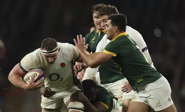 England's Sam Underhill, , left, us tackled by South Africa's Jasper Wiese during the Autumn Nations series rugby union match between England and South Africa, at Twickenham, in London, Saturday, Nov. 16, 2024. (AP Photo/Ian Walton)