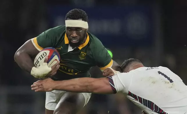 South Africa's Siya Kolisi is tackled by England's Ellis Genge during the Autumn Nations series rugby union match between England and South Africa, at Twickenham, in London, Saturday, Nov. 16, 2024. (AP Photo/Kin Cheung)