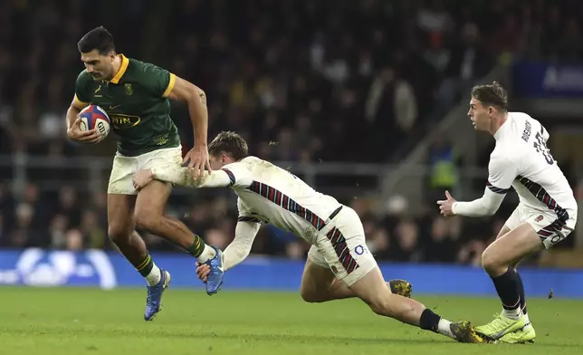 South Africa's Damian de Allende, is tackled by England's Tommy Freeman during the Autumn Nations series rugby union match between England and South Africa, at Twickenham, in London, Saturday, Nov. 16, 2024. (AP Photo/Ian Walton)