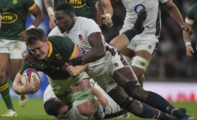 South Africa's Jasper Wiese, is brought down by England's Maro Itoje during the Autumn Nations series rugby union match between England and South Africa, at Twickenham, in London, Saturday, Nov. 16, 2024. (AP Photo/Kin Cheung)