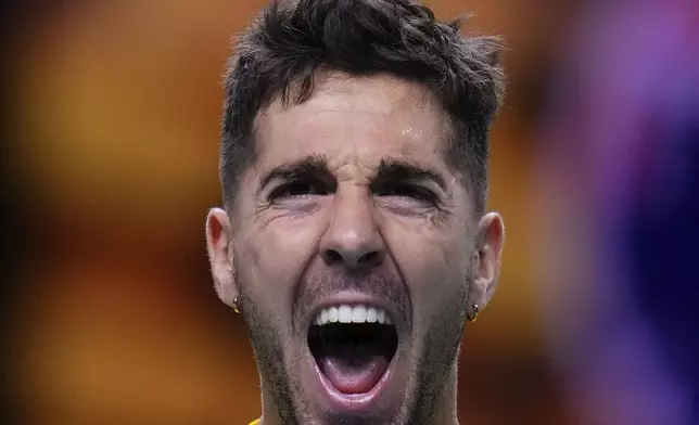 Australia's Athanasios Kokkinakis celebrates after winning against Ben Shelton of the United States during a Davis Cup quarterfinal match at the Martin Carpena Sports Hall, in Malaga, southern Spain, on Thursday, Nov. 21, 2024. (AP Photo/Manu Fernandez)