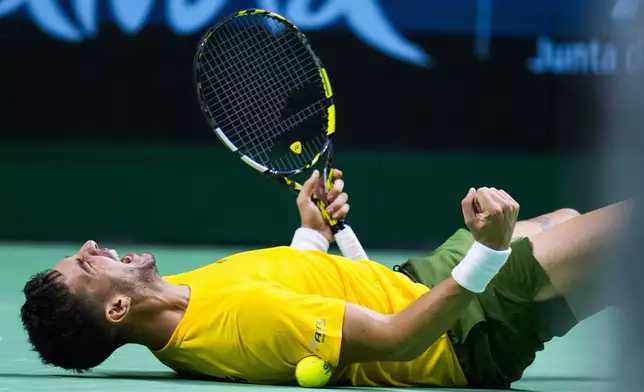 Australia's Athanasios Kokkinakis celebrates after winning against Ben Shelton of the United States during a Davis Cup quarterfinal match at the Martin Carpena Sports Hall, in Malaga, southern Spain, on Thursday, Nov. 21, 2024. (AP Photo/Manu Fernandez)