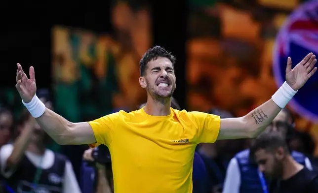 Australia's Athanasios Kokkinakis celebrates after winning against Ben Shelton of the United States during a Davis Cup quarterfinal match at the Martin Carpena Sports Hall, in Malaga, southern Spain, on Thursday, Nov. 21, 2024. (AP Photo/Manu Fernandez)