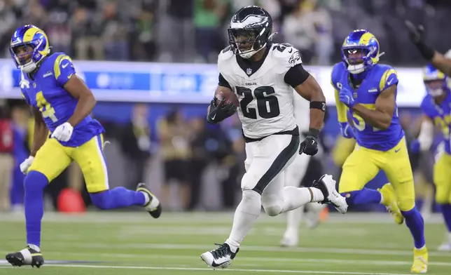 Philadelphia Eagles running back Saquon Barkley (26) runs for a touchdown against the Los Angeles Rams during the second half of an NFL football game in Inglewood, Calif., Sunday, Nov. 24, 2024. (AP Photo/Ryan Sun)