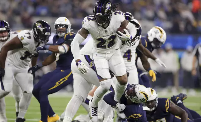 Baltimore Ravens running back Derrick Henry (22) is tackled by Los Angeles Chargers cornerback Tarheeb Still (29) during the second half of an NFL football game Monday, Nov. 25, 2024, in Inglewood, Calif. (AP Photo/Ryan Sun)