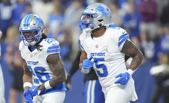 Detroit Lions running back David Montgomery (5) and running back Jahmyr Gibbs (26) celebrate after Montgomery's 6-yard rushing touchdown during the first half of an NFL football game against the Indianapolis Colts, Sunday, Nov. 24, 2024, in Indianapolis. (AP Photo/Michael Conroy)