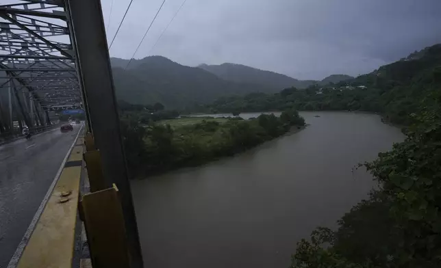 A bridge stand over the Chamelecón river during rains brought on by tropical storm Sara in San Pedro Sula, Honduras, Friday, Nov. 15, 2024. (AP Photo/Moises Castillo)