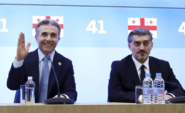 In this photo released by the Georgian Dream party, Bidzina Ivanishvili, leader of the created Georgian Dream party which he initiated, left, gestures as Mikheil Kavelashvili, who was nominated by the governing Georgian Dream party, sits next during a session to discussing Presidential candidate in Tbilisi, Georgia, Wednesday, Nov. 27, 2024. (Georgian Dream party via AP)