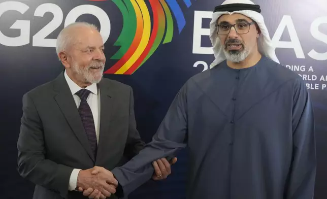 Brazil's President Luiz Inacio Lula da Silva, left, shakes hands with United Arab Emirates President Sheikh Mohamed bin Zayed Al Nahyan, during a bilateral meeting a day before the opening of the G20 Summit, in Rio de Janeiro, Sunday, Nov. 17, 2024. (AP Photo/Eraldo Peres)