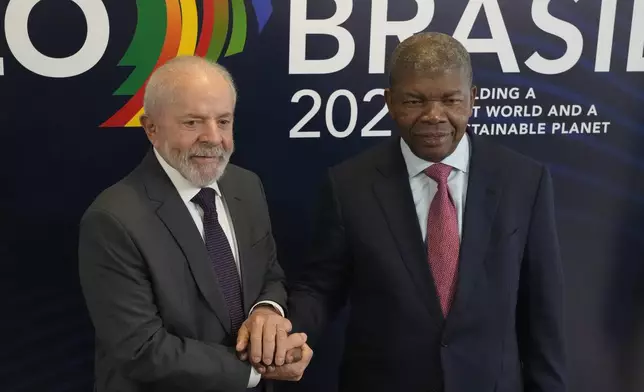 Brazil's President Luiz Inacio Lula da Silva, left, poses for photos with Angola's President Joao Manuel Goncalves Lourenco, during a bilateral meeting a day before the opening of the G20 Summit, in Rio de Janeiro, Sunday, Nov. 17, 2024. (AP Photo/Eraldo Peres)