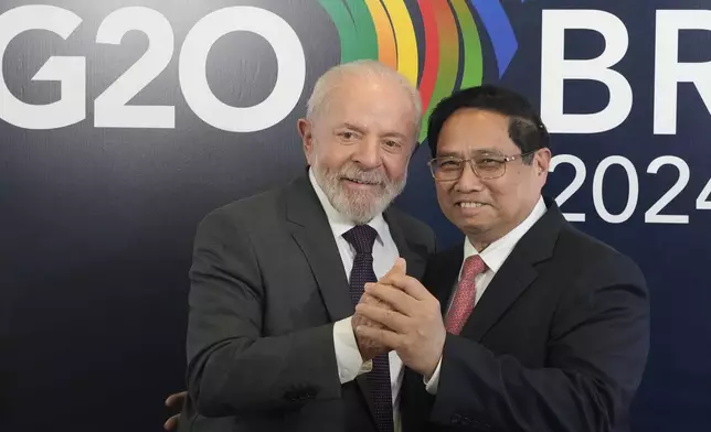 Brazil's President Luiz Inacio Lula da Silva, left, shakes hands with Vietnam's Prime Minister Pham Minh Chinh during a bilateral meeting a day before the opening of the G20 Summit, in Rio de Janeiro, Sunday, Nov. 17, 2024. (AP Photo/Eraldo Peres)