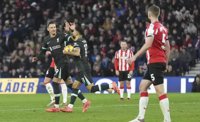 Liverpool's Mohamed Salah, right, celebrates with Darwin Nunez after scoring during the English Premier League soccer match between Southampton and Liverpool in Southampton, England, Sunday, Nov. 24, 2024. (AP Photo/Sean Ryan)