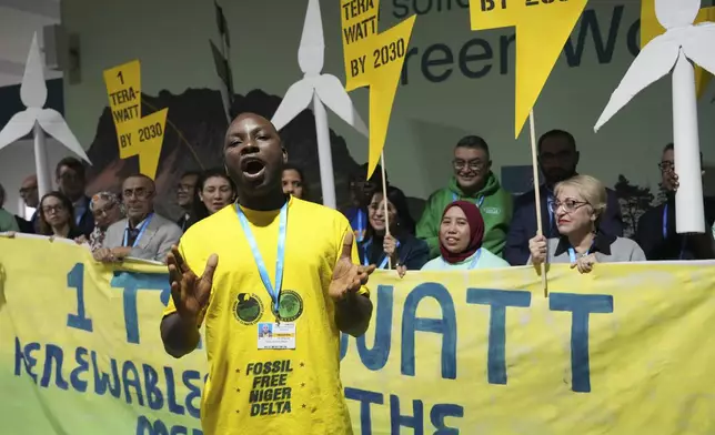 Activist Friday Barilule Nbani leads a demonstration for clean energy at the COP29 U.N. Climate Summit, Monday, Nov. 18, 2024, in Baku, Azerbaijan. (AP Photo/Sergei Grits)