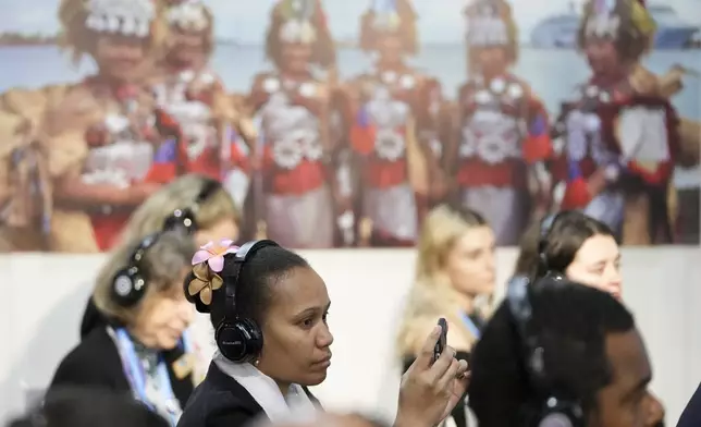 Attendees gather in the Moana Blue Pacific Pavilion at the COP29 U.N. Climate Summit, Monday, Nov. 18, 2024, in Baku, Azerbaijan. (AP Photo/Sergei Grits)