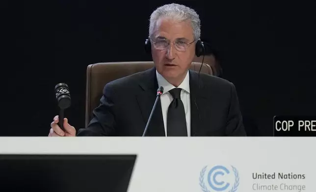 Mukhtar Babayev, COP29 President, bangs a gavel during a plenary session at the COP29 U.N. Climate Summit, Monday, Nov. 18, 2024, in Baku, Azerbaijan. (AP Photo/Rafiq Maqbool)