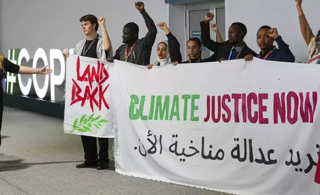 Activists demonstrate for climate justice and a ceasefire in the Israel-Hamas at the COP29 U.N. Climate Summit, Monday, Nov. 11, 2024, in Baku, Azerbaijan. (AP Photo/Peter Dejong)