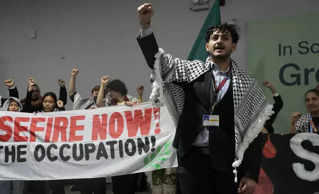 Activist Mohammed Usrof participates in a demonstration for climate justice and a ceasefire in the Israel-Hamas at the COP29 U.N. Climate Summit, Monday, Nov. 11, 2024, in Baku, Azerbaijan. (AP Photo/Rafiq Maqbool)