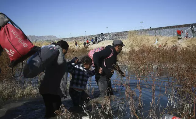 FILE - Migrants cross the Rio Grande to reach the United States from Ciudad Juarez, Mexico, Dec. 27, 2023. (AP Photo/Christian Chavez, File)