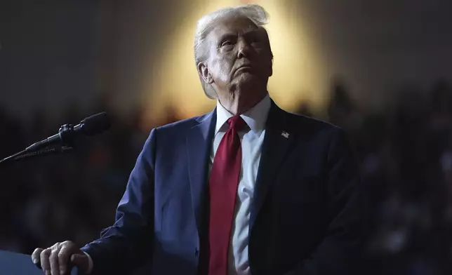 FILE - Republican presidential nominee former President Donald Trump watches a video screen at a campaign rally at the Salem Civic Center, in Salem, Va, Nov. 2, 2024. (AP Photo/Evan Vucci, File)