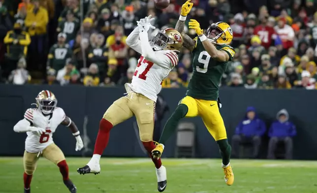 San Francisco 49ers safety Ji'Ayir Brown (27) breaks up a pass intended for Green Bay Packers wide receiver Christian Watson (9) during the second half of an NFL football game on Sunday, Nov. 24, 2024 in Green Bay, Wis. (AP Photo/Mike Roemer)