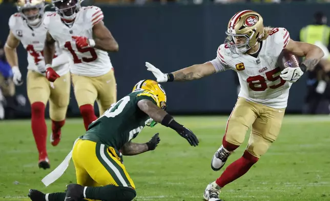 San Francisco 49ers tight end George Kittle (85) avoids a tackle during the second half of an NFL football game against the Green Bay Packers on Sunday, Nov. 24, 2024 in Green Bay, Wis. (AP Photo/Mike Roemer)