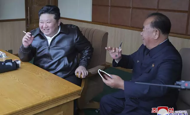 In this photo provided by the North Korean government, its leader Kim Jong Un, left, inspects tests of drones designed to crash into targets, at an undisclosed location in North Korea, Thursday, Nov. 14, 2024. Independent journalists were not given access to cover the event depicted in this image distributed by the North Korean government. The content of this image is as provided and cannot be independently verified. Korean language watermark on image as provided by source reads: "KCNA" which is the abbreviation for Korean Central News Agency. (Korean Central News Agency/Korea News Service via AP)