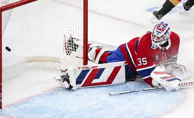 Montreal Canadiens goaltender Sam Montembeault looks back on his net after being scored on by Vegas Golden Knights' Ivan Barbashev, not shown, during the second period of an NHL hockey game in Montreal, Saturday, Nov. 23, 2024. (Graham Hughes/The Canadian Press via AP)