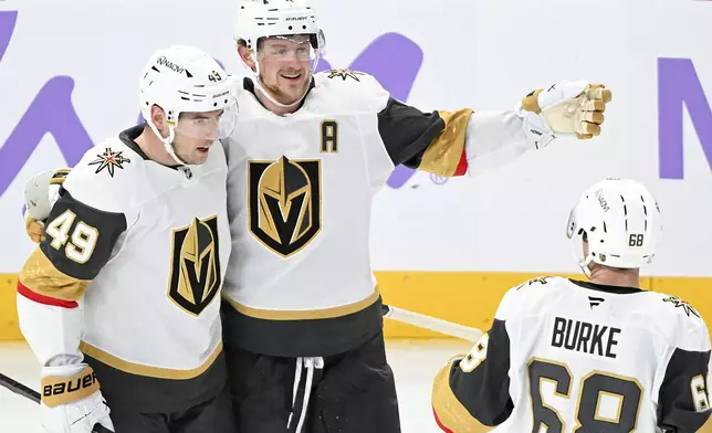 Vegas Golden Knights' Ivan Barbashev (49) celebrates with teammates Jack Eichel (9) and Callahan Burke after scoring against the Montreal Canadiens during second period NHL hockey action in Montreal, Saturday, Nov. 23, 2024. (Graham Hughes/The Canadian Press via AP)