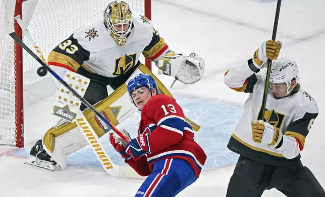 Montreal Canadiens' Cole Caufield (13) tries to knock down a loose puck as Vegas Golden Knights goaltender Adin Hill and Golden Knights' Kaedan Korczak (6) look on during the first period of an NHL hockey game in Montreal, Saturday, Nov. 23, 2024. (Graham Hughes/The Canadian Press via AP)