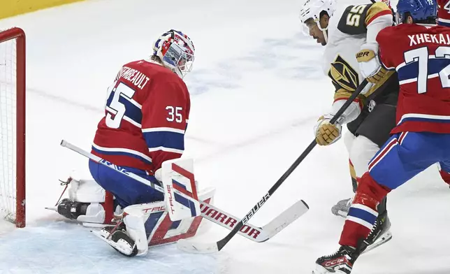 Vegas Golden Knights Keegan Kolesar (55) scores against Montreal Canadiens goaltender Sam Montembeault as Canadiens' Arber Xhekaj (72) defends during the second period of an NHL hockey game in Montreal, Saturday, Nov. 23, 2024. (Graham Hughes/The Canadian Press via AP)