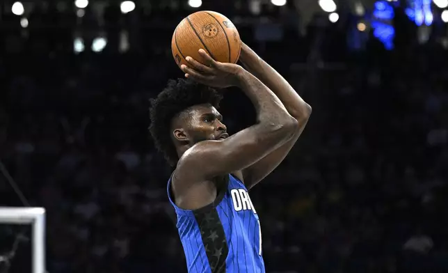 Orlando Magic forward Jonathan Isaac (1) goes up to shoot a three-point basket during the first half of an Emirates NBA Cup basketball game against the Philadelphia 76ers, Friday, Nov. 15, 2024, in Orlando, Fla. (AP Photo/Phelan M. Ebenhack)