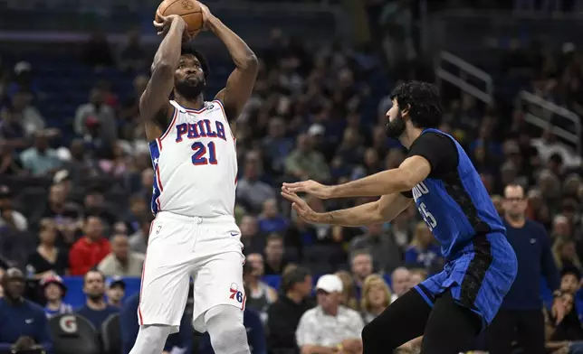 Philadelphia 76ers center Joel Embiid (21) shoots in front of Orlando Magic center Goga Bitadze (35) during the first half of an Emirates NBA Cup basketball game, Friday, Nov. 15, 2024, in Orlando, Fla. (AP Photo/Phelan M. Ebenhack)