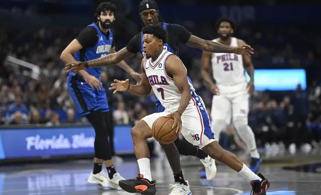 Philadelphia 76ers guard Kyle Lowry (7) drives to the basket as Orlando Magic guard Kentavious Caldwell-Pope defends during the first half of an Emirates NBA Cup basketball game, Friday, Nov. 15, 2024, in Orlando, Fla. (AP Photo/Phelan M. Ebenhack)