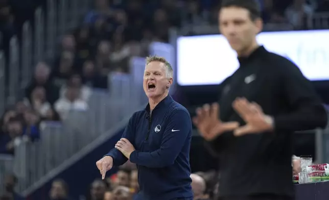 Golden State Warriors head coach Steve Kerr, left, reacts during the first half of an NBA basketball game against the Oklahoma City Thunder, Wednesday, Nov. 27, 2024, in San Francisco. (AP Photo/Godofredo A. Vásquez)