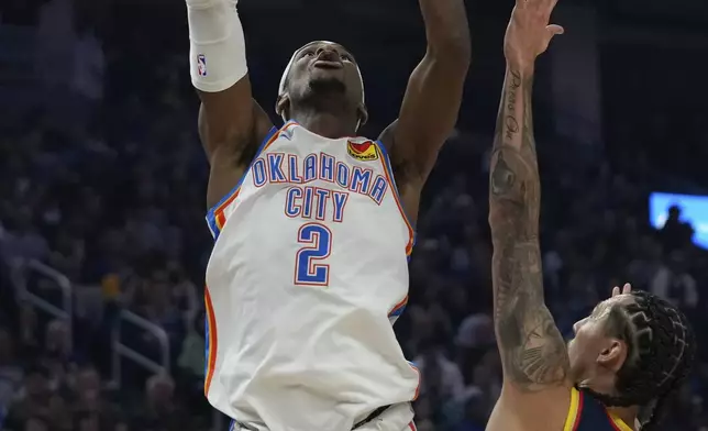 Oklahoma City Thunder guard Shai Gilgeous-Alexander, left, shoots over Golden State Warriors forward Lindy Waters III during the first half of an NBA basketball game Wednesday, Nov. 27, 2024, in San Francisco. (AP Photo/Godofredo A. Vásquez)