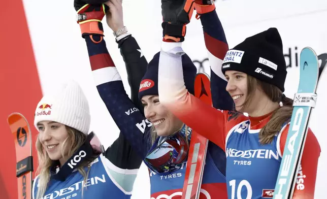 United States' Mikaela Shiffrin, center, winner of an alpine ski, women's World Cup slalom, celebrates with second-placed Albania's Lara Colturi, left, and third-placed Switzerland's Camille Rast, in Gurgl, Austria, Saturday, Nov. 23, 2024. (AP Photo/Gabriele Facciotti)