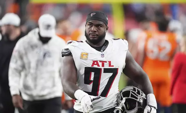 Atlanta Falcons defensive end Grady Jarrett heads off the field after an NFL football game against the Denver Broncos, Sunday, Nov. 17, 2024, in Denver. (AP Photo/David Zalubowski)