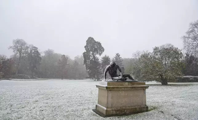 Snow covers the statue "Wounded gladiator" of the gardens of the Fontainebleau castle, in Fontainebleau, south of Paris, Thursday, Nov. 21, 2024. (AP Photo/Thibault Camus)