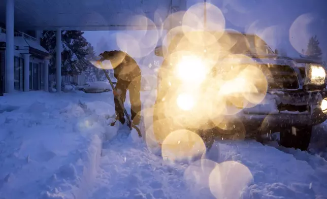 Daniel Sandoval tries to dig out his truck that got stuck in snow after dropping off his daughter at work in Weed, Calif., Wednesday, Nov. 20, 2024. (Carlos Avila Gonzalez/San Francisco Chronicle via AP)