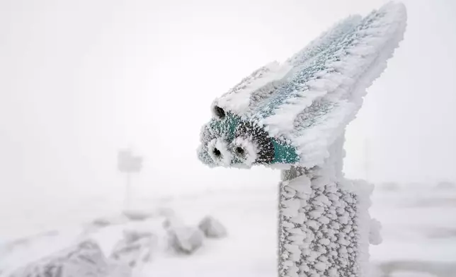 A snow covered telescope stands on northern Germany's 1,142-meter (3,743 feet) highest mountain 'Brocken' at the Harz mountains near Schierke, Germany, Wednesday, Nov. 20, 2024. (AP Photo/Matthias Schrader)