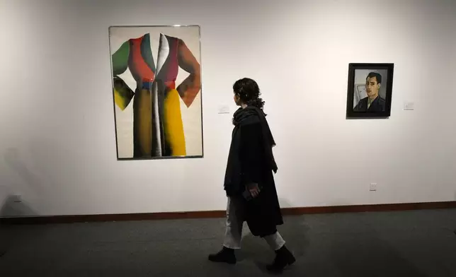 A woman visits an exhibition titled Eye to Eye which showcases over 120 works by modern world artists as well as Iranian painters at Tehran Museum of Contemporary Art, in Tehran, Thursday, Nov. 21, 2024. (AP Photo/Vahid Salemi)