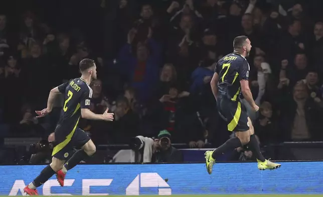 Scotland's John McGinn, right, celebrates after scoring the opening goal during the UEFA Nations League soccer match between Scotland and Croatia at Hampden Park in Glasgow, Scotland, Friday, Nov. 15, 2024. (AP Photo/Scott Heppell)