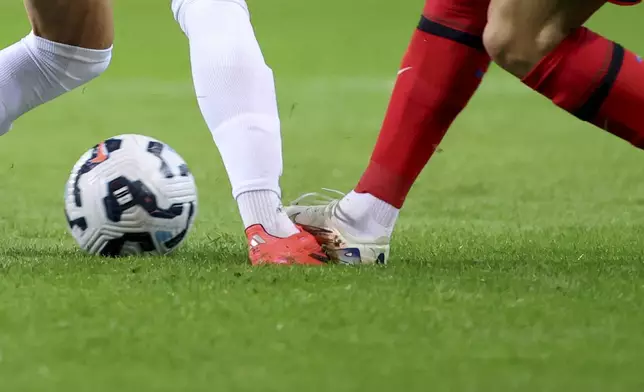 Portugal's Cristiano Ronaldo steps on the foot of Poland's Kacper Urbanski during the UEFA Nations League soccer match between Portugal and Poland at the Dragao stadium in Porto, Portugal, Friday, Nov. 15, 2024. (AP Photo/Luis Vieira)