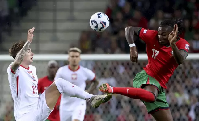 Portugal's Rafael Leao, right, vies for the ball with Poland's Nicola Zalewski during the UEFA Nations League soccer match between Portugal and Poland at the Dragao stadium in Porto, Portugal, Friday, Nov. 15, 2024. (AP Photo/Luis Vieira)