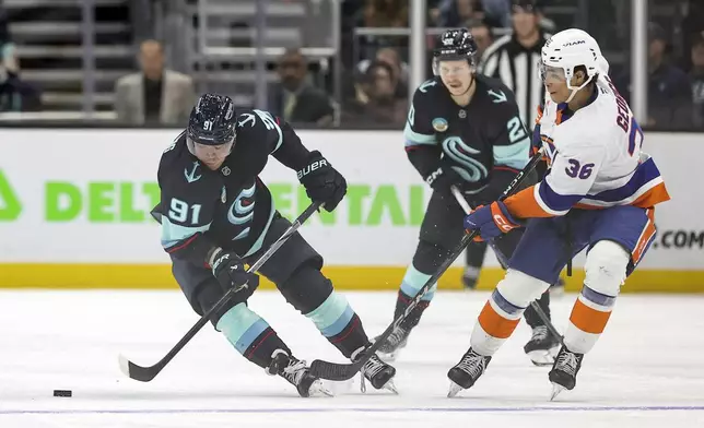 Seattle Kraken right wing Daniel Sprong (91) skates against New York Islanders defenseman Isaiah George (36) during the second period of an NHL hockey game, Saturday, Nov. 16, 2024, in Seattle. (AP Photo/Rio Giancarlo)