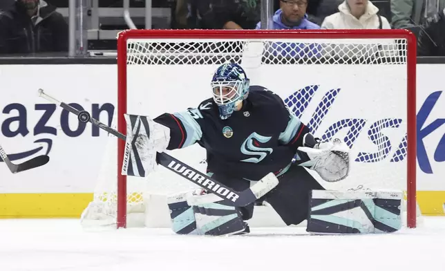 Seattle Kraken goaltender Joey Daccord makes a save against the New York Islanders during the second period of an NHL hockey game, Saturday, Nov. 16, 2024, in Seattle. (AP Photo/Rio Giancarlo)