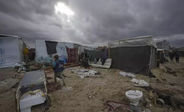 Storm clouds loom over the tents occupied by displaced Palestinians on the beach front in Deir al-Balah, Gaza Strip, Tuesday Nov. 26, 2024. (AP Photo/Abdel Kareem Hana)