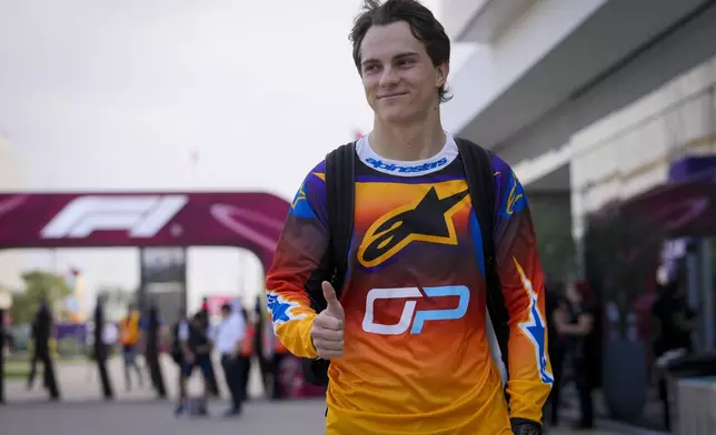 McLaren driver Oscar Piastri of Australia walks through paddock as he arrives at the Lusail International Circuit in Lusail, Qatar, ahead of the Qatar Grand Prix, Thursday, Nov. 28, 2024. (AP Photo/Darko Bandic)